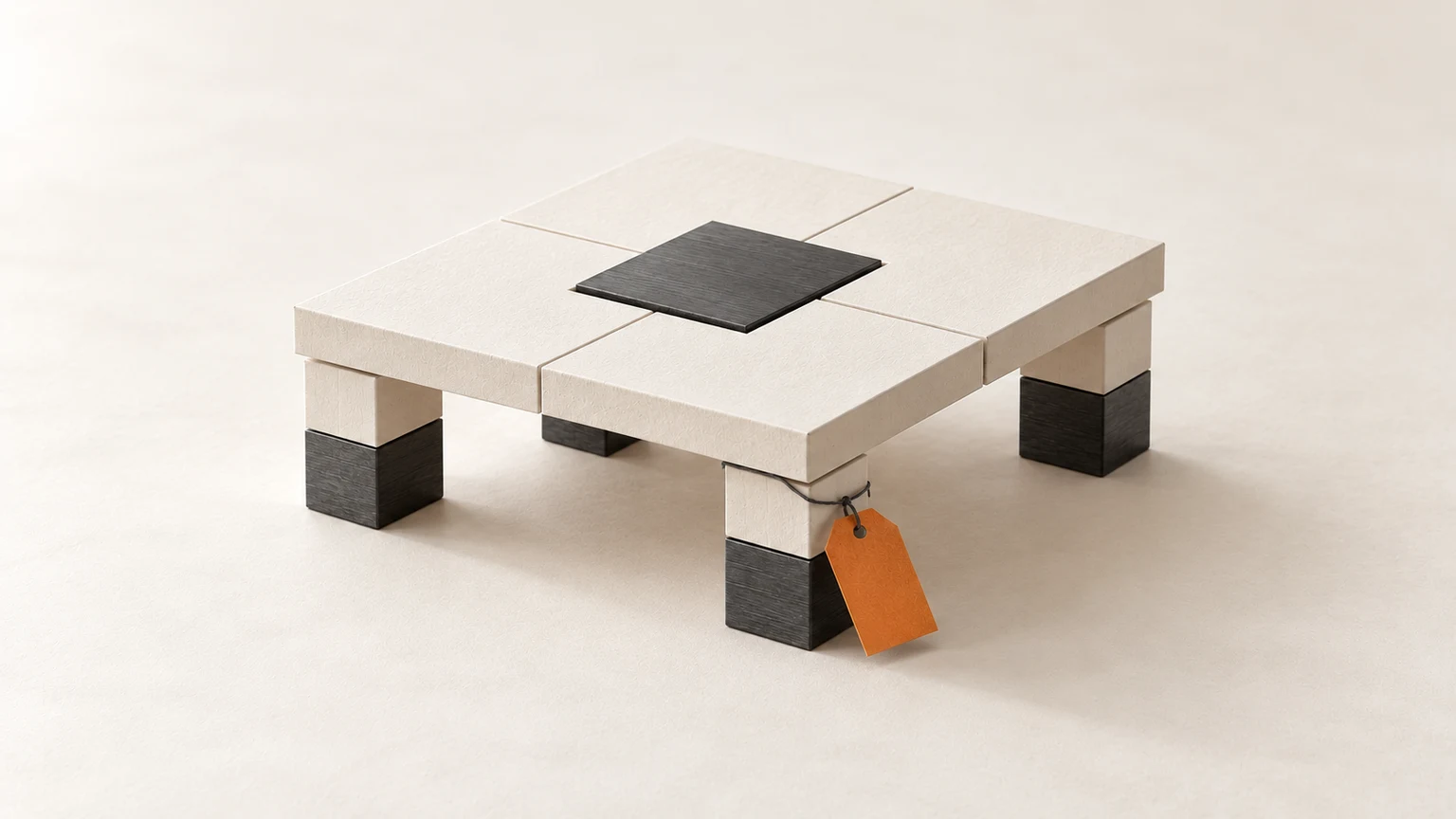An intact cream and graphite structure resting on four short pillars, with a blank orange tag tied to one support.