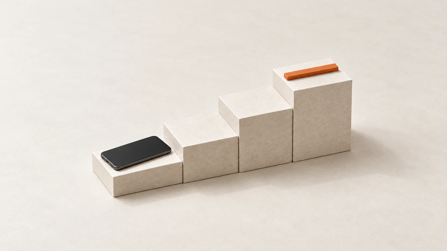 A blank graphite smartphone on the lowest of four cream paper-board steps, with a thin orange bar across the highest step.